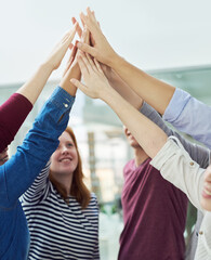 Poster - We work together as one. Shot of a group of people putting their hands up together.