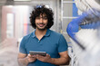 © Westend61 - Smiling technician holding tablet PC standing in factory