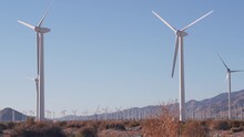 Windmills Turbine Rotating, Wind Farm Power Plant, Alternative Green Renewable Energy Generators, Industrial Field In California Desert USA. Electricity Generation On Windfarm. Palm Springs, Coachella