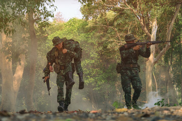 army soldier with rifle and machine gun moving .Thai army soldier in combat uniforms with machine gun.