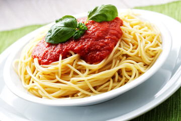 Wall Mural - Spaghetti with tomato sauce and basil on a plate