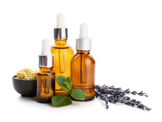 Bottles of natural essential oils on white background