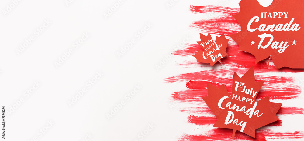 Paper maple leaves with text HAPPY CANADA DAY on white background