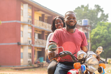 african bike man carrying a lady