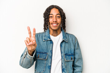 Young African American man isolated on white background joyful and carefree showing a peace symbol with fingers.