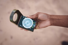 Anonymous Black Traveling Woman With Compass On Seashore