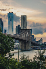 Wall Mural - Famous Brooklyn Bridge in New York under a cloudy sky during the sunset