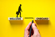 Welcome onboard symbol. Concept words Welcome onboard on wooden blocks on a beautiful yellow table yellow background. Businessman hand. Business onboarding and welcome onboard concept, copy space.