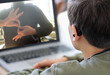 © Praewphan - Deaf teenager boy Wearing Hearing Aid using Laptop. Disable student with disabilities deafness distancing learning online from home making communication hands language with teacher via VDO call.