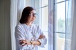 © Valerii Honcharuk - Business middle aged woman looking out the window.