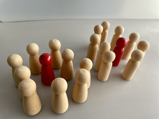 Close-up shot of wooden figures on a grey background