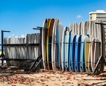 Multicolored Surfboards Standing On A Board Rack On A Hawaiian Beach
