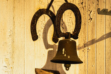 Closeup Of An Old Rusty Bell Hanging On A Wall