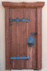 Wall Mural - wooden door with beautiful decorative metal trim in the historic old Russian city of Pskov