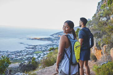 youre my favourite view. shot of a young couple enjoying the sunset view while out on a hike on a mo