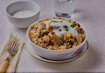 Wall Mural - Chicken,lentils and ginger pilaf, garnished with yogurt.