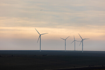 Closeup of windmills with a beautiful sky in the background