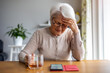 © pikselstock - Senior woman feeling pain while consulting doctor on her smart phone