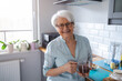 © pikselstock - Portrait of smiling senior woman at home