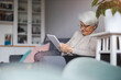 © pikselstock - Senior woman using a digital tablet at home