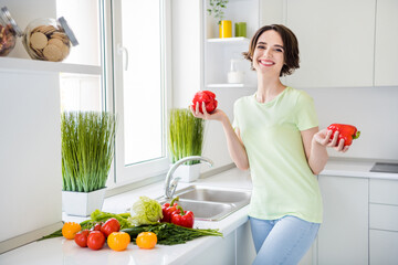 Wall Mural - Photo of cheerful pretty lady arms hold red paprika toothy smile good mood weekend kitchen indoors