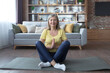 © Liubomir - Older gray-haired woman at home alone, active lifestyle, yoga, lotus position and meditating