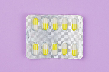 Wall Mural - Blister or pack of ten medical tablets or pills. Light purple background.