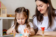 © Дарья Колпакова - Montessori material. Mom teaches her daughter how to brush her teeth while playing.