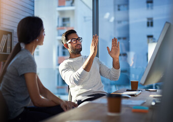 Wall Mural - turning his vision into reality. shot of a young businessman explaining an idea to his coworker at w