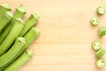 Background With Raw Green Okra On Wood With Copy Space