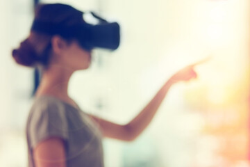 Aufkleber - Connecting to a world of opportunity. Defocused shot of a young businesswoman wearing a VR headset while connecting to a user interface in an office.