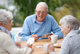 I can beat these two. A group of senior citizens playing cards together.