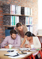 Canvas Print - Going through every detail. Young creative professionals working in an office.