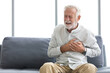© offsuperphoto - senior elderly man chest pain or suffering from heart attack on a sofa