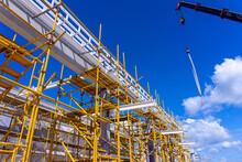 Building Construction Site With Yellow Scaffolding , Installation Roof Steel Structure
