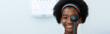 Young woman african american using occluder for eye test ophthalmological in optics clinic. woman checkup eye health with equipment ophthalmology medical in hospital. Banner copy space.
