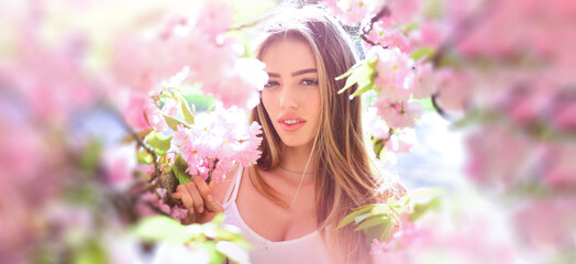 Beauty spring woman face. Happy beautiful young girl relaxing in blossom park. Banner for header website design, copy space.