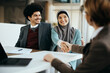 © Drazen - Happy Muslim couple shaking hands with their financial advisor after successful meeting in the office.