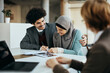 © Drazen - Young happy Muslim couple signs contract with real estate argent during meeting in the office.