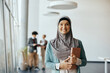 © Drazen - Portrait of happy Muslim businesswoman at corporate office looking at camera.