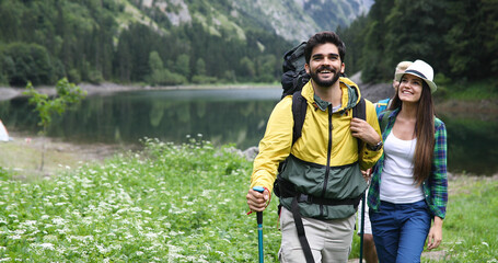 Wall Mural - Group of friends on a hiking, camping trip in the mountains