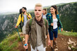 © NDABCREATIVITY - Group of happy fit friends hiking, trekking together outdoor nature