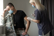 © Angelov - Soldier in uniform receiving vaccine shot against corona virus at the clinic. Military vaccination and immunization