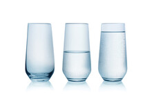 Empty, Half Full And Full Glasses Of Water On White Background