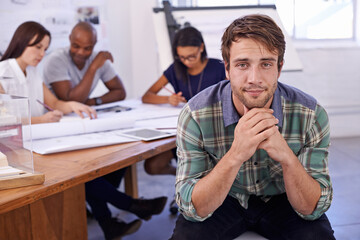 Sticker - He has a mind for design. Portrait of a handsome male architect with his colleagues working in the background.