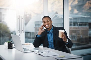 Poster - He knows everything about business. Shot of a handsome young businessman talking on a cellphone while working in an office.