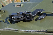 Enlarged Fragment And Texture Of Military Armored Vehicles. Large Iron Black Hook With A Winch Block For Pulling Out A Vehicle. Military Tracked Vehicles. Green Military Khaki Camouflage.