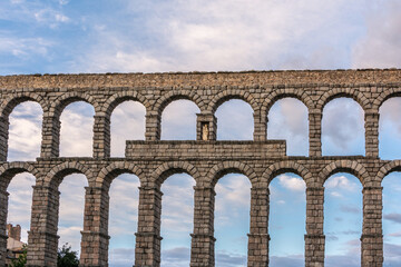 Wall Mural - The famous Roman aqueduct of Segovia in Spain. Heritage of humanity by unesco. stone for the construction of a road