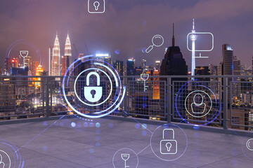 Rooftop with concrete terrace, Kuala Lumpur night skyline. Cyber security concept to protect clients confidential information. IT hologram padlock icons. City downtown. Double exposure.