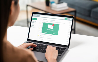 woman using computer on table with new email message on laptop, communication connection message to 